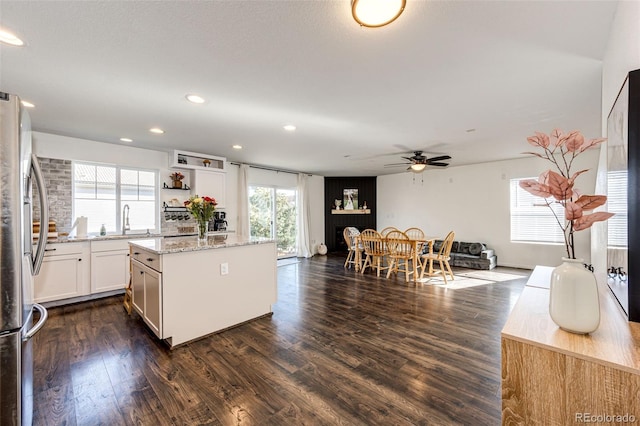 kitchen featuring a wealth of natural light, white cabinetry, and dark hardwood / wood-style floors