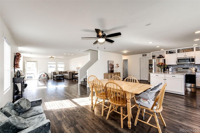 dining area featuring ceiling fan and dark hardwood / wood-style flooring