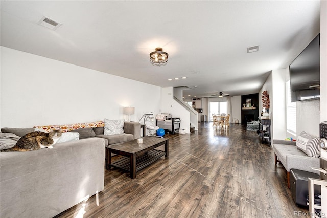 living room with dark hardwood / wood-style floors and ceiling fan