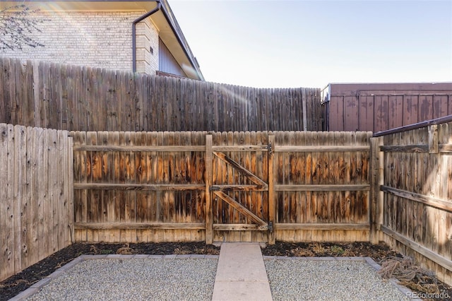 view of yard with fence and a gate