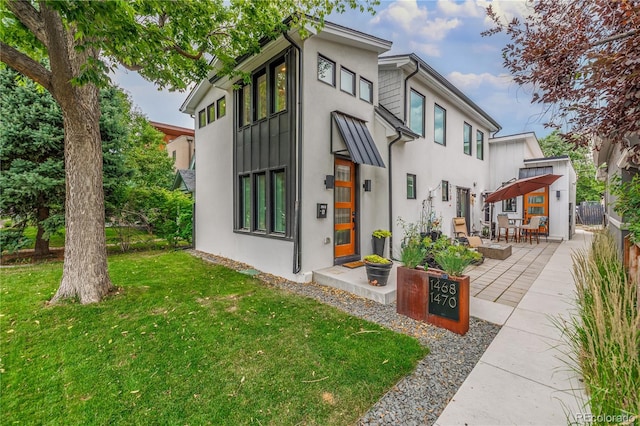 exterior space with a patio and a front lawn