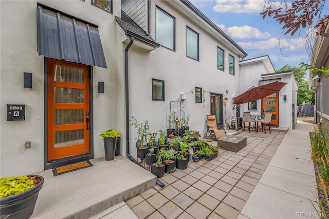 property entrance featuring a patio area