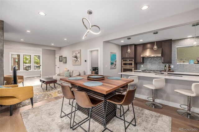 dining area featuring sink and light hardwood / wood-style floors