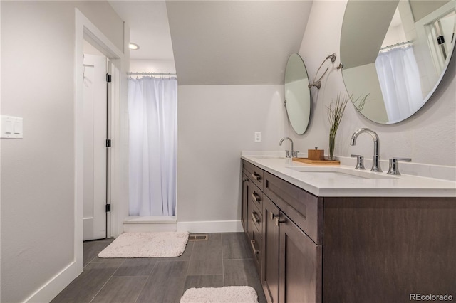 bathroom featuring a shower with shower curtain and vanity