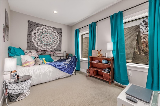 carpeted bedroom with multiple windows