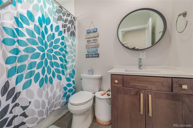 bathroom with vanity, toilet, and walk in shower