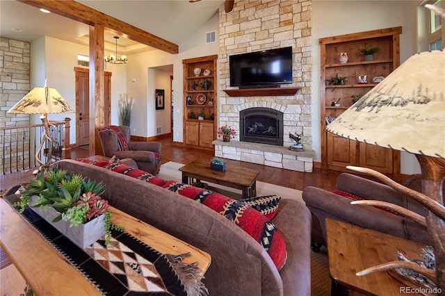 living room with wood finished floors, built in features, a stone fireplace, baseboards, and a chandelier