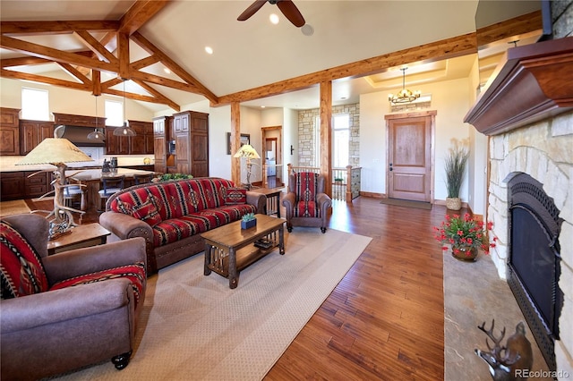 living area with dark wood-style flooring, beamed ceiling, a ceiling fan, recessed lighting, and a stone fireplace