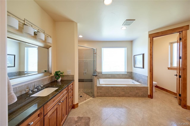 full bathroom with a stall shower, toilet, vanity, a bath, and tile patterned floors