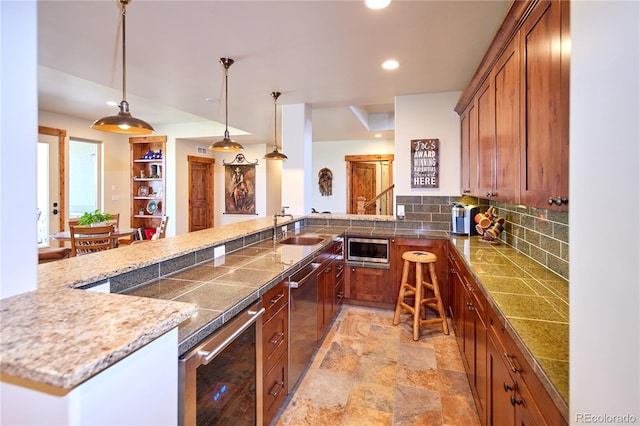 kitchen with wine cooler, a sink, brown cabinets, recessed lighting, and stainless steel appliances