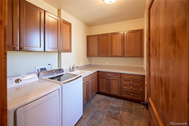 laundry area with cabinet space, washer and clothes dryer, and stone finish flooring