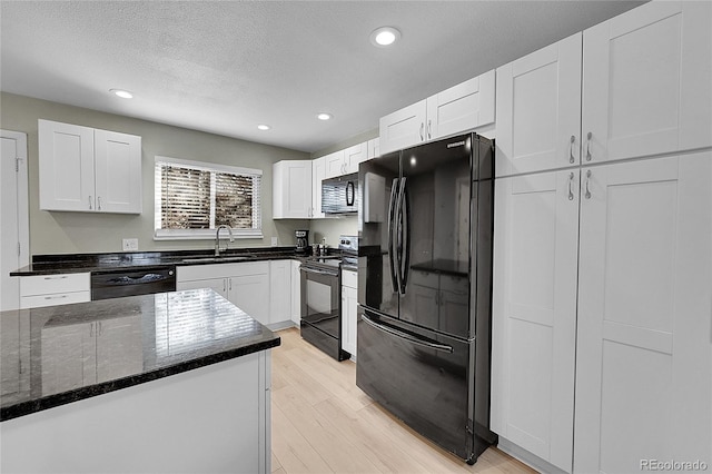 kitchen featuring white cabinetry and black appliances