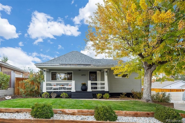 bungalow-style home featuring a front lawn and covered porch