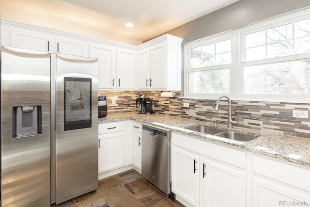 16102 Grebe Pl, Parker, CO 80134 - kitchen featuring appliances with stainless steel finishes, a sink, decorative backsplash, white cabinets, and recessed lighting