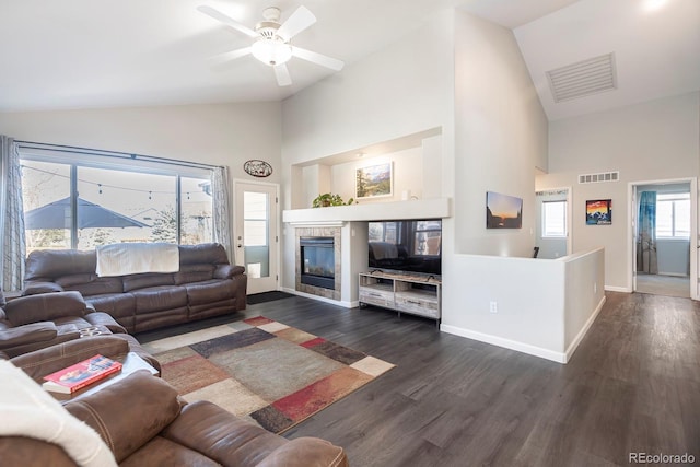 16102 Grebe Pl, Parker, CO 80134 - living area featuring high vaulted ceiling, a ceiling fan, dark wood-style flooring, baseboards, and a tile fireplace