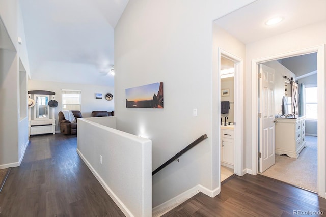 16102 Grebe Pl, Parker, CO 80134 - hallway with baseboards, dark wood-style flooring, an upstairs landing, lofted ceiling, and a sink