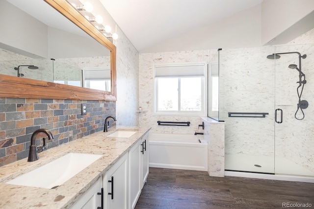 16102 Grebe Pl, Parker, CO 80134 - full bath featuring wood finished floors, a shower stall, vaulted ceiling, a bath, and double vanity