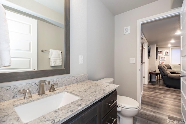 16102 Grebe Pl, Parker, CO 80134 - half bath with toilet, wood finished floors, and vanity