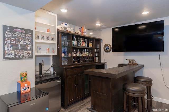 16102 Grebe Pl, Parker, CO 80134 - indoor dry bar featuring dark wood-type flooring, refrigerator, baseboards, and recessed lighting