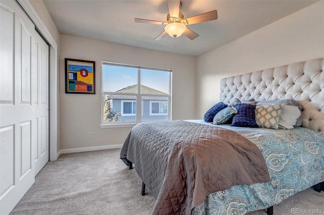 bedroom featuring ceiling fan, light colored carpet, and a closet