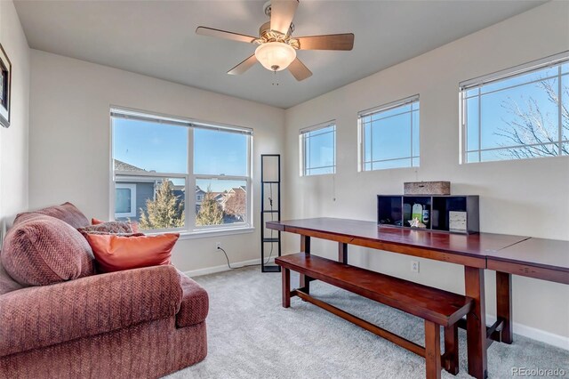 office space featuring ceiling fan and light carpet