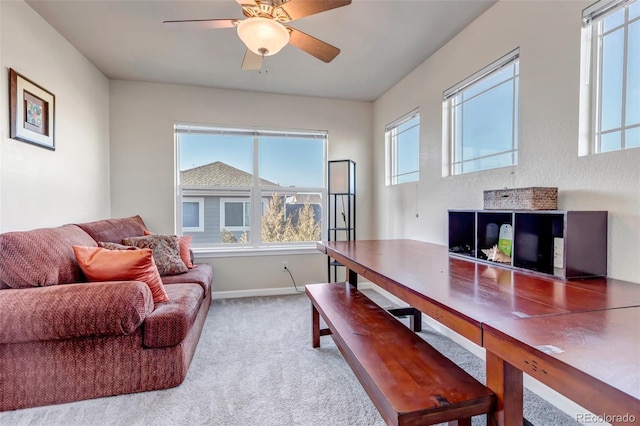 carpeted office space featuring ceiling fan