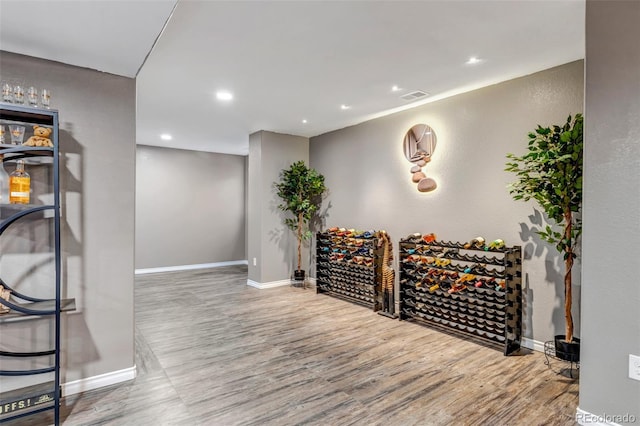 wine cellar with hardwood / wood-style flooring