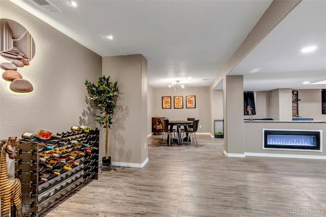 interior space featuring wood-type flooring and a notable chandelier