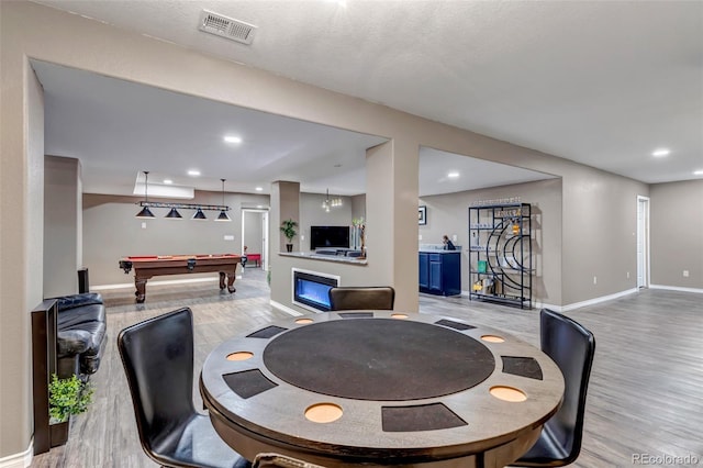 interior space featuring pool table and light hardwood / wood-style floors