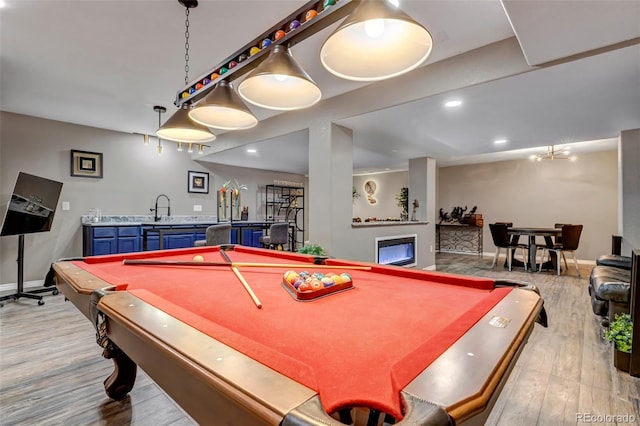 rec room featuring indoor wet bar, billiards, and light hardwood / wood-style flooring