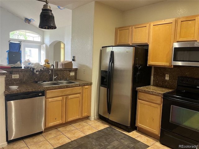 14400 Albrook Dr Unit 88, Denver, CO 80239 - kitchen featuring stainless steel appliances, a sink, decorative backsplash, arched walkways, and light tile patterned floors