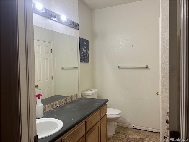 14400 Albrook Dr Unit 88, Denver, CO 80239 - bathroom with vanity, toilet, and baseboards