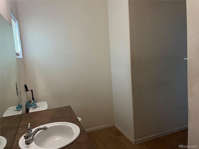 14400 Albrook Dr Unit 88, Denver, CO 80239 - bathroom with tile patterned flooring, vanity, and baseboards