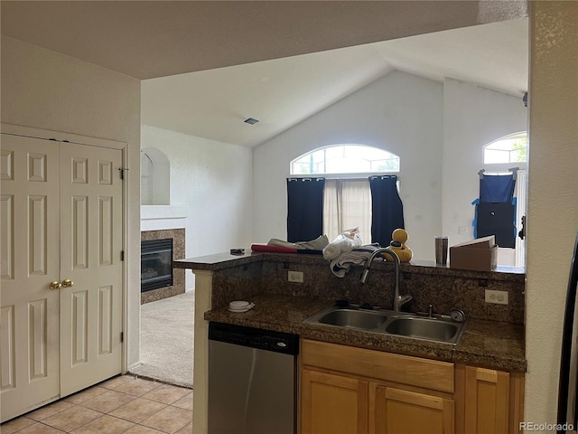 14400 Albrook Dr Unit 88, Denver, CO 80239 - kitchen featuring stainless steel dishwasher, a sink, light tile patterned floors, open floor plan, and lofted ceiling