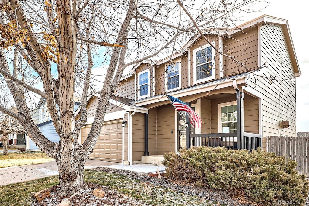 view of front of house featuring a porch and a garage