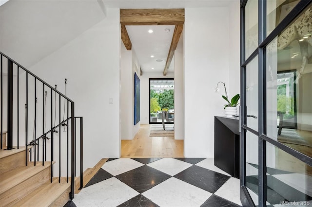 interior space with beam ceiling and hardwood / wood-style flooring