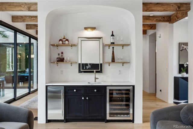 bar featuring beam ceiling, refrigerator, wine cooler, and sink