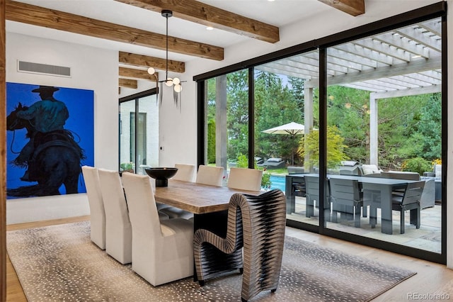 dining space featuring beam ceiling and light hardwood / wood-style floors