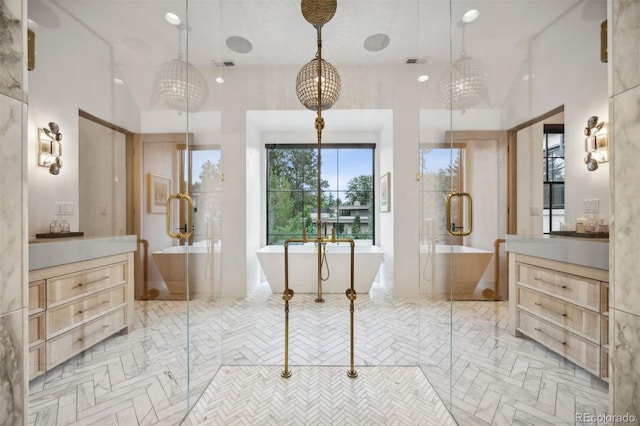 bathroom featuring lofted ceiling, a bath, and a chandelier