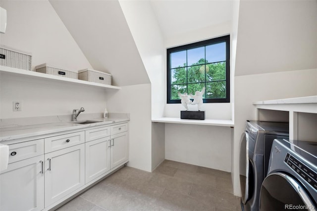 clothes washing area featuring cabinets, independent washer and dryer, and sink