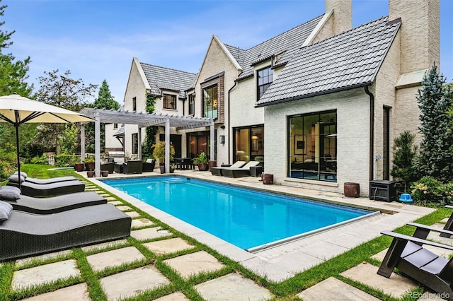 back of house featuring outdoor lounge area, a pergola, and a patio area