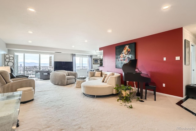 living room featuring carpet floors, baseboards, a wealth of natural light, and recessed lighting