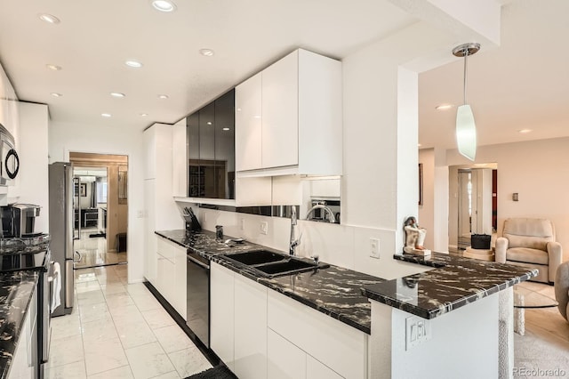 kitchen featuring white cabinets, stainless steel appliances, a sink, and recessed lighting