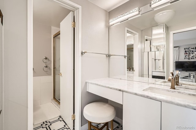 full bathroom with a shower stall and vanity