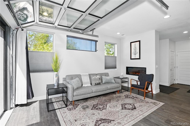 12497 W Virginia Ave, Lakewood, CO 80228 - living area featuring recessed lighting, baseboards, a glass covered fireplace, and wood finished floors