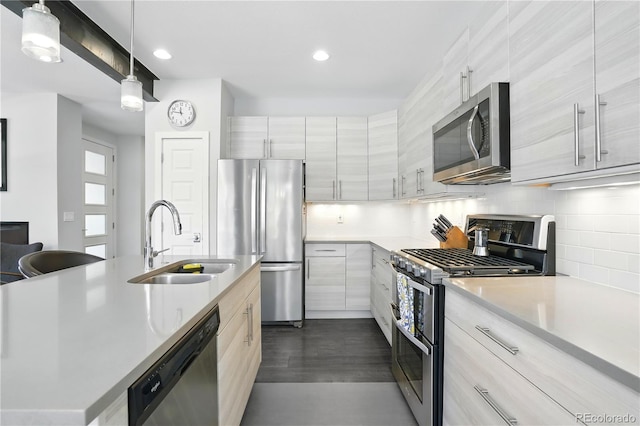 12497 W Virginia Ave, Lakewood, CO 80228 - kitchen with a sink, light countertops, modern cabinets, and appliances with stainless steel finishes