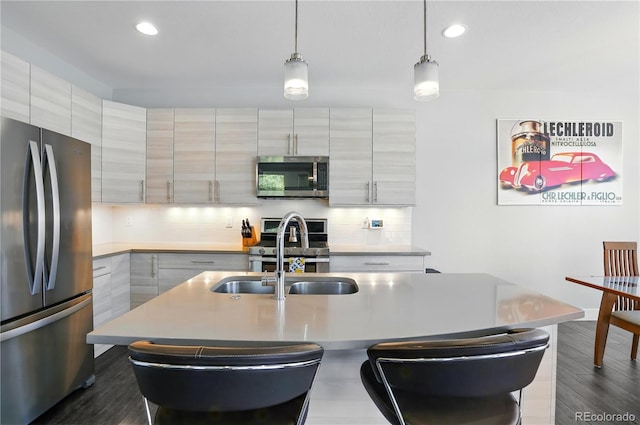 12497 W Virginia Ave, Lakewood, CO 80228 - kitchen with a breakfast bar, tasteful backsplash, appliances with stainless steel finishes, and a sink