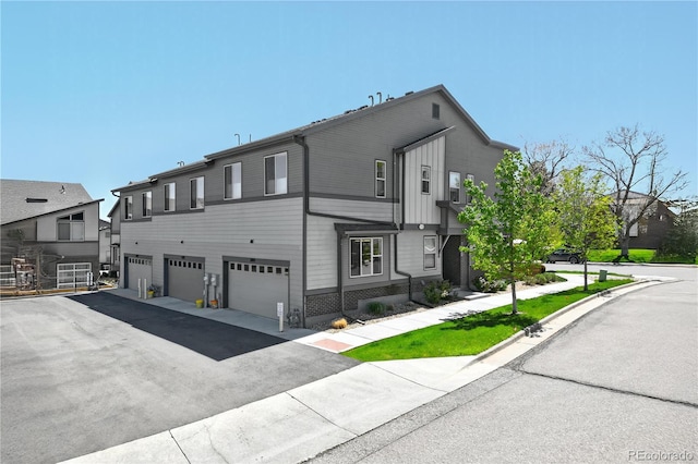 12497 W Virginia Ave, Lakewood, CO 80228 - view of front of home featuring an attached garage and driveway