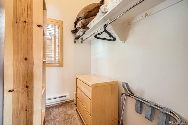 spacious closet with light colored carpet and baseboard heating