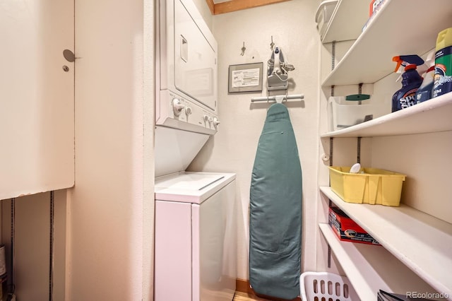 laundry area featuring stacked washing maching and dryer